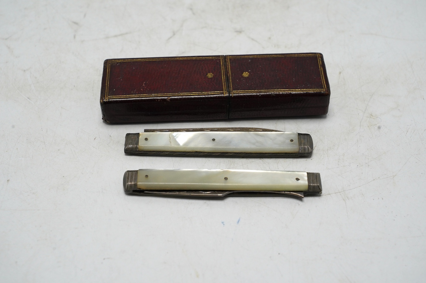 A George III mother of pearl handled silver travelling folding knife and fork, Sheffield, 1816, in original red leather case. Condition - good